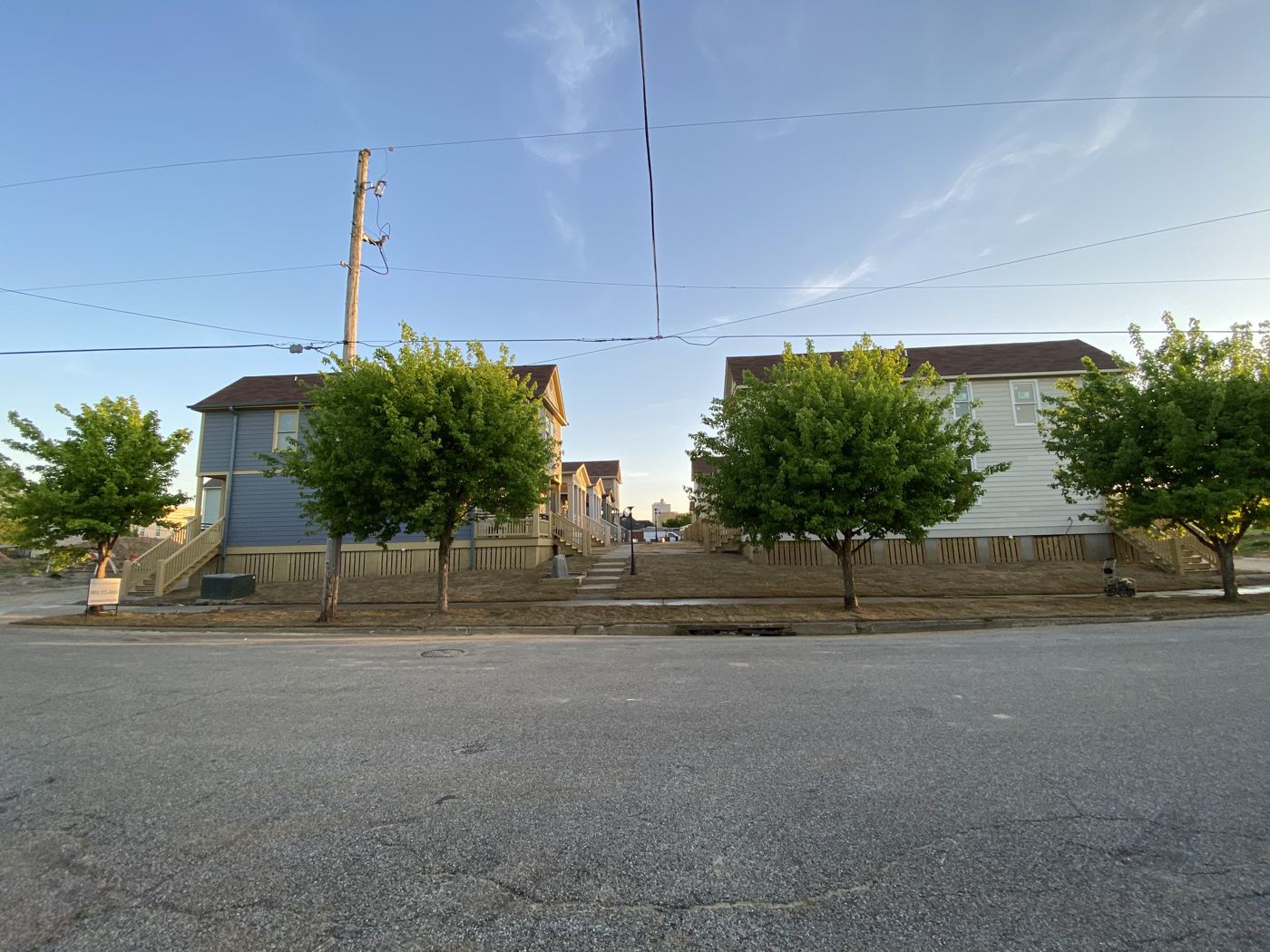 Street corner at Malone Park Commons with young street trees and cottages