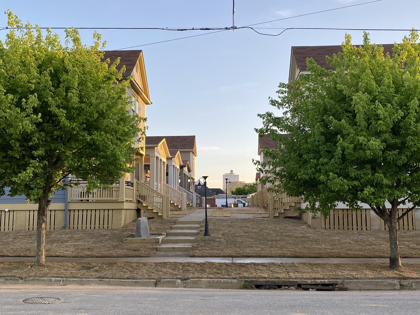 Street trees and front porches along a walk at Malone Park Commons